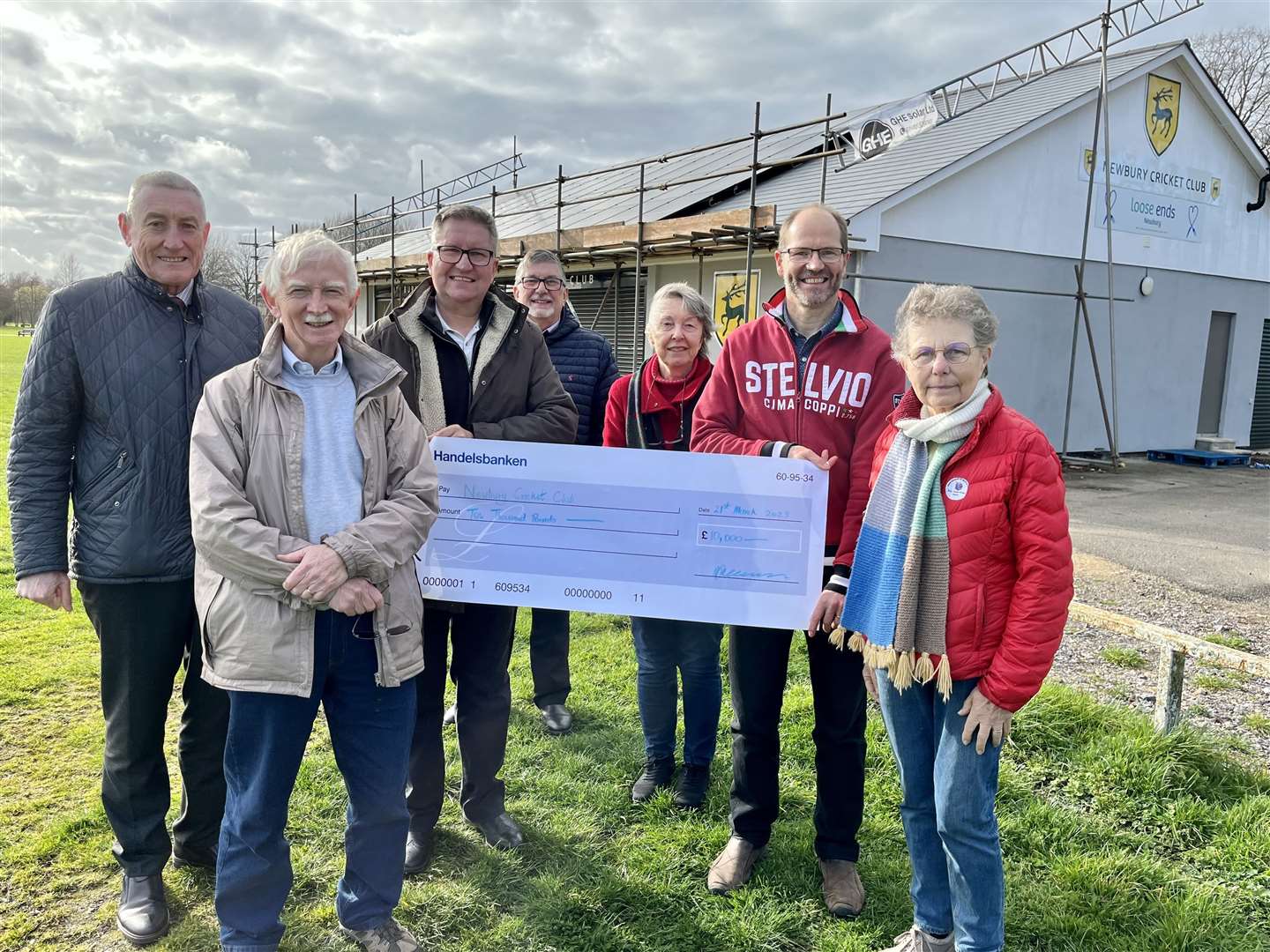 Chequer handover at Newbury Cricket Club. L to R: Hugh Peacocke, Councillor Andy Moore, John Sullivan, Community Services Manager David Ingram, Pat Burke, Councillor Martin Colston and Councillor Martha Vickers