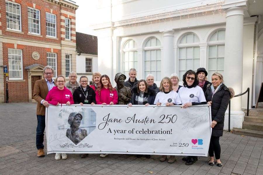 The Basingstoke and Deane Jane Austen 250 group, pictured with the statue of Jane Austen in front of The Willis Museum in Market Place, Basingstoke
