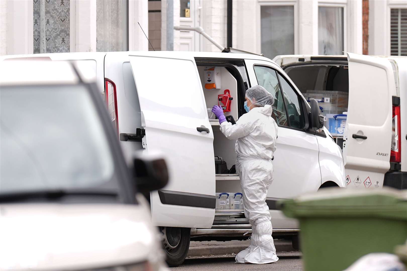 Forensics officers and police in Newcomen Road (Joe Giddens/PA)