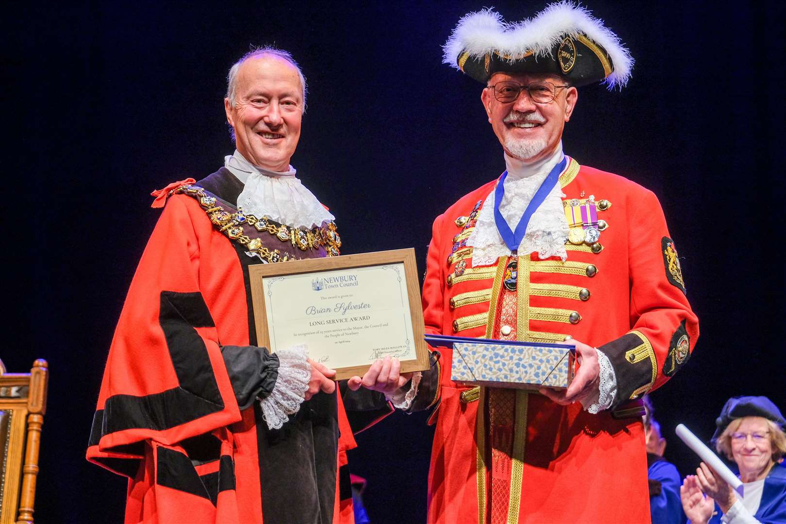 Outgoing mayor Nigel Foot presents town crier Brian Sylvester with a certificate for 25 years service and a retirement gift