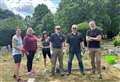Volunteers tidy up old graves at cemetery