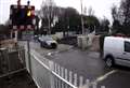 Pedestrians climbing over lowered barriers at level crossing