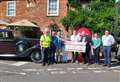 Classic car show presents cheque to charity