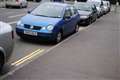 Contractors paint yellow lines between parked Thatcham cars