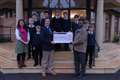Ugandan teacher receives donation from Newtown school