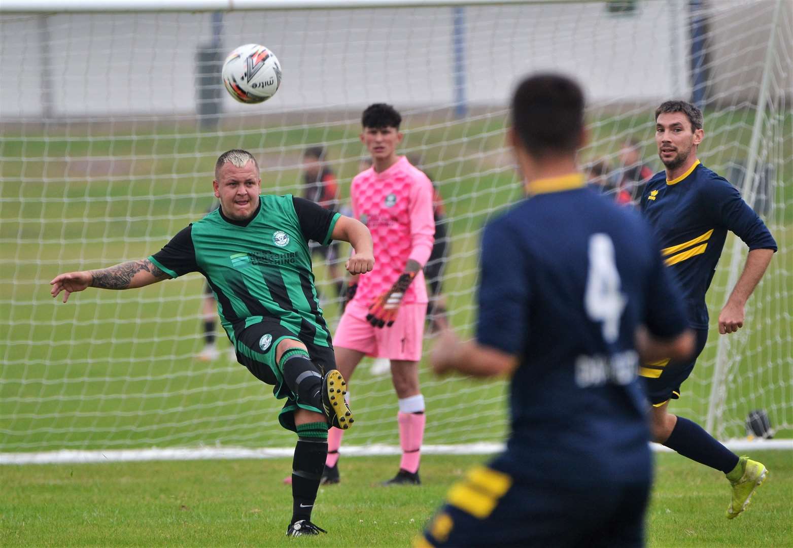 The defender clears the ball