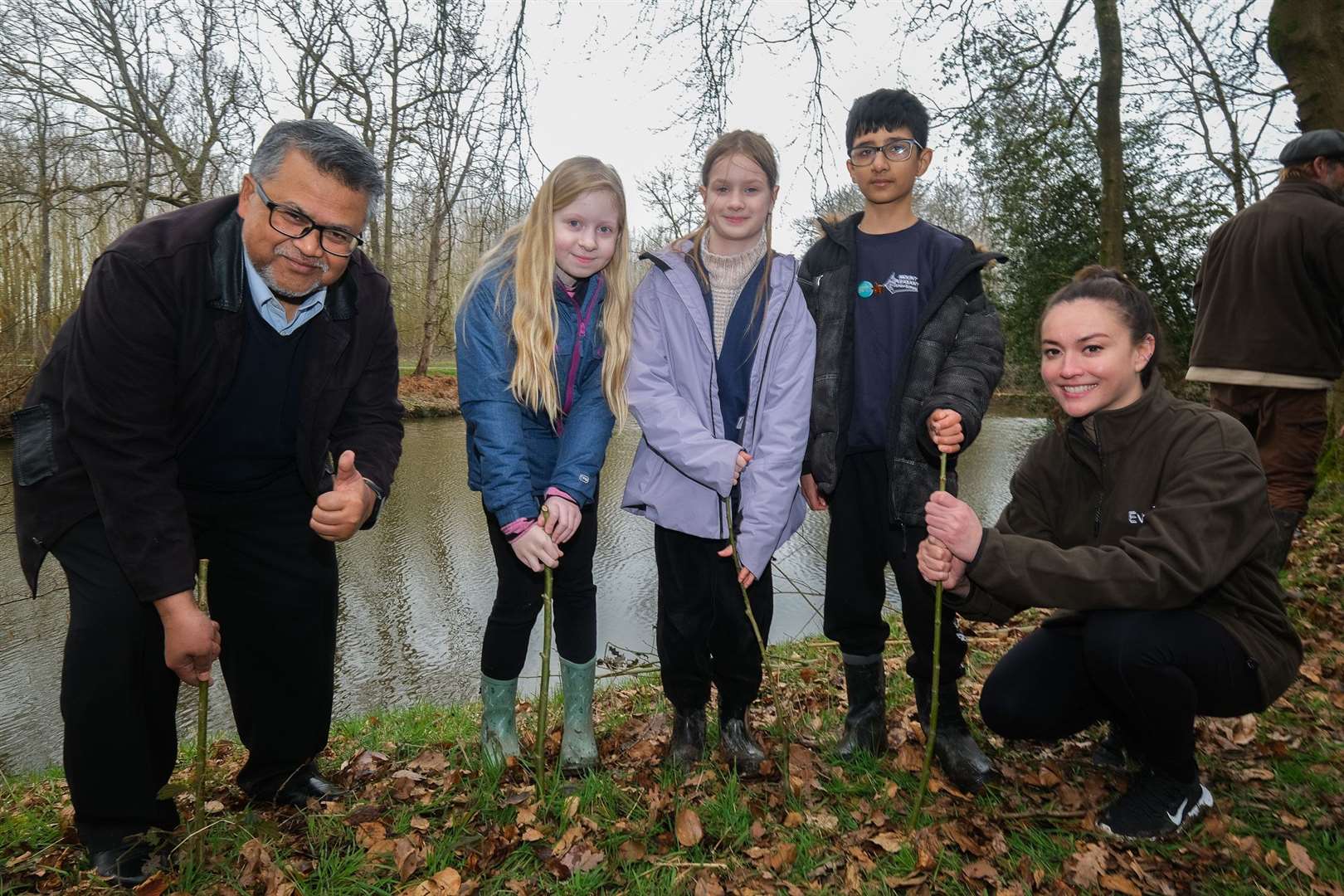 The Malaysian High Commissioner to London Dato’ Zakri Jaafar and Mandy Lieu plant willow trees with schoolchildren in the beaver enclosure