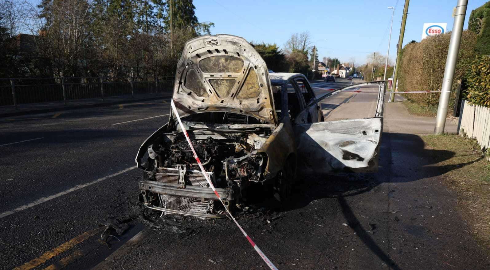 Burnt out car left outside the Esso petrol station on London Road