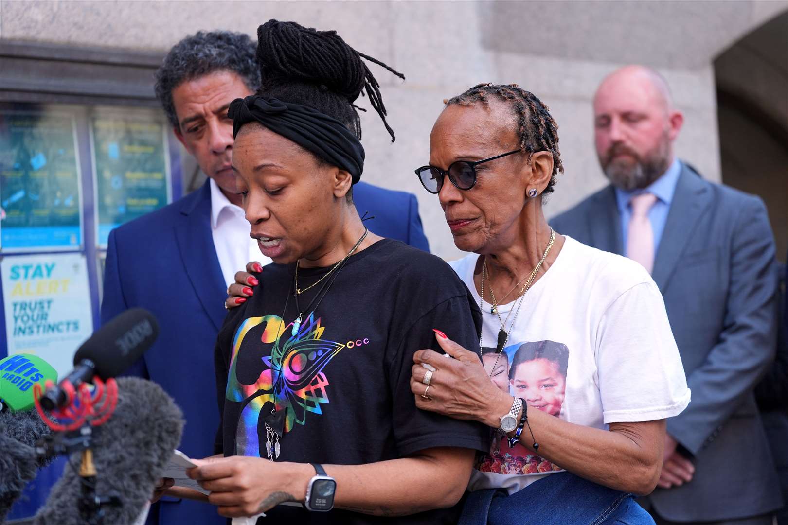 A relative of Cher Maximen, TJ Jacobs (left), is accompanied by Cher’s grandmother Vyleen Maximen (right), as she speaks outside the Old Bailey (Yui Mok/PA)