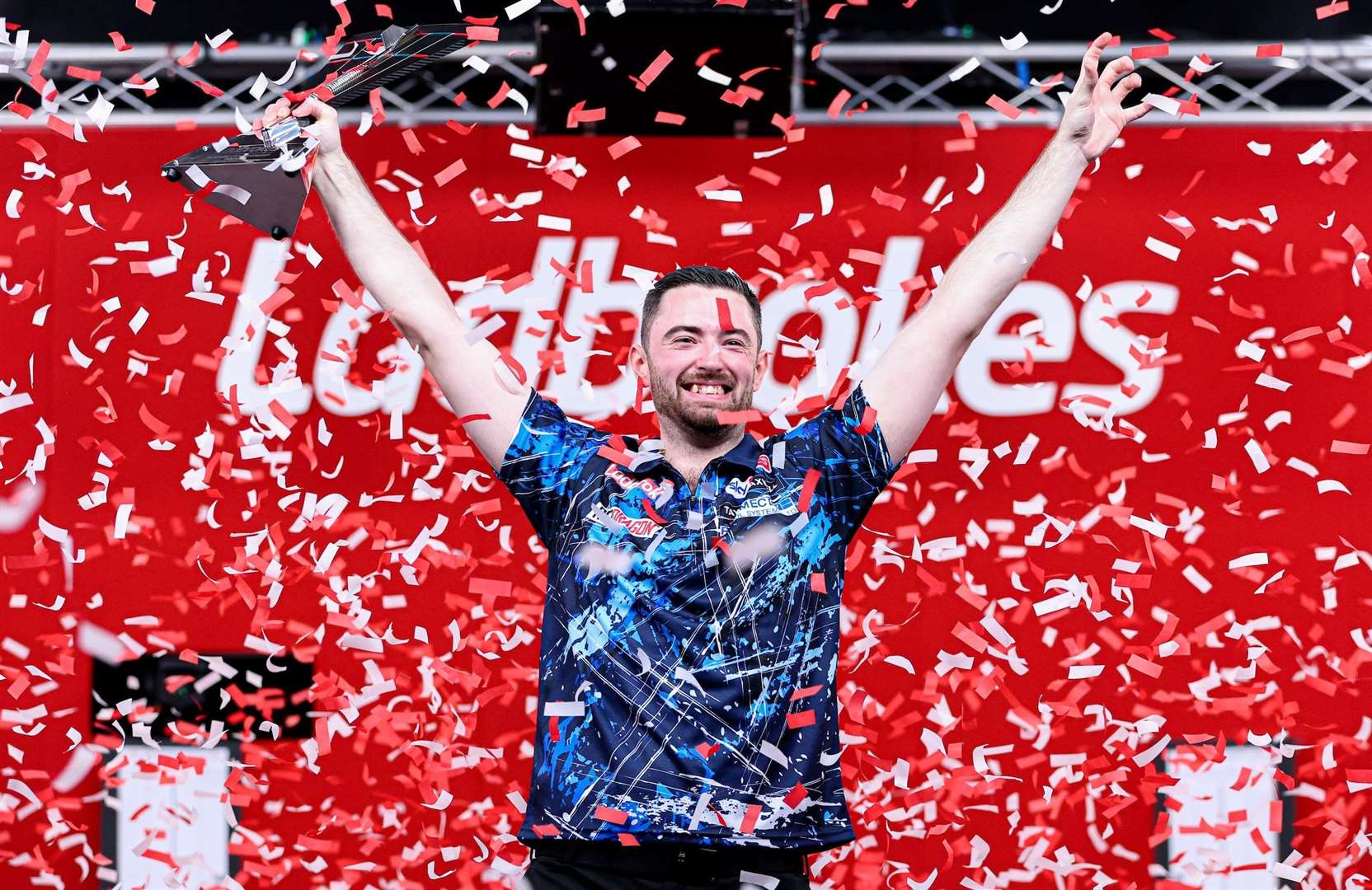 Luke Humphries celebrates retaining the Players Championship, after defeating Luke Littler - Photo: Kieran Cleeves/PDC
