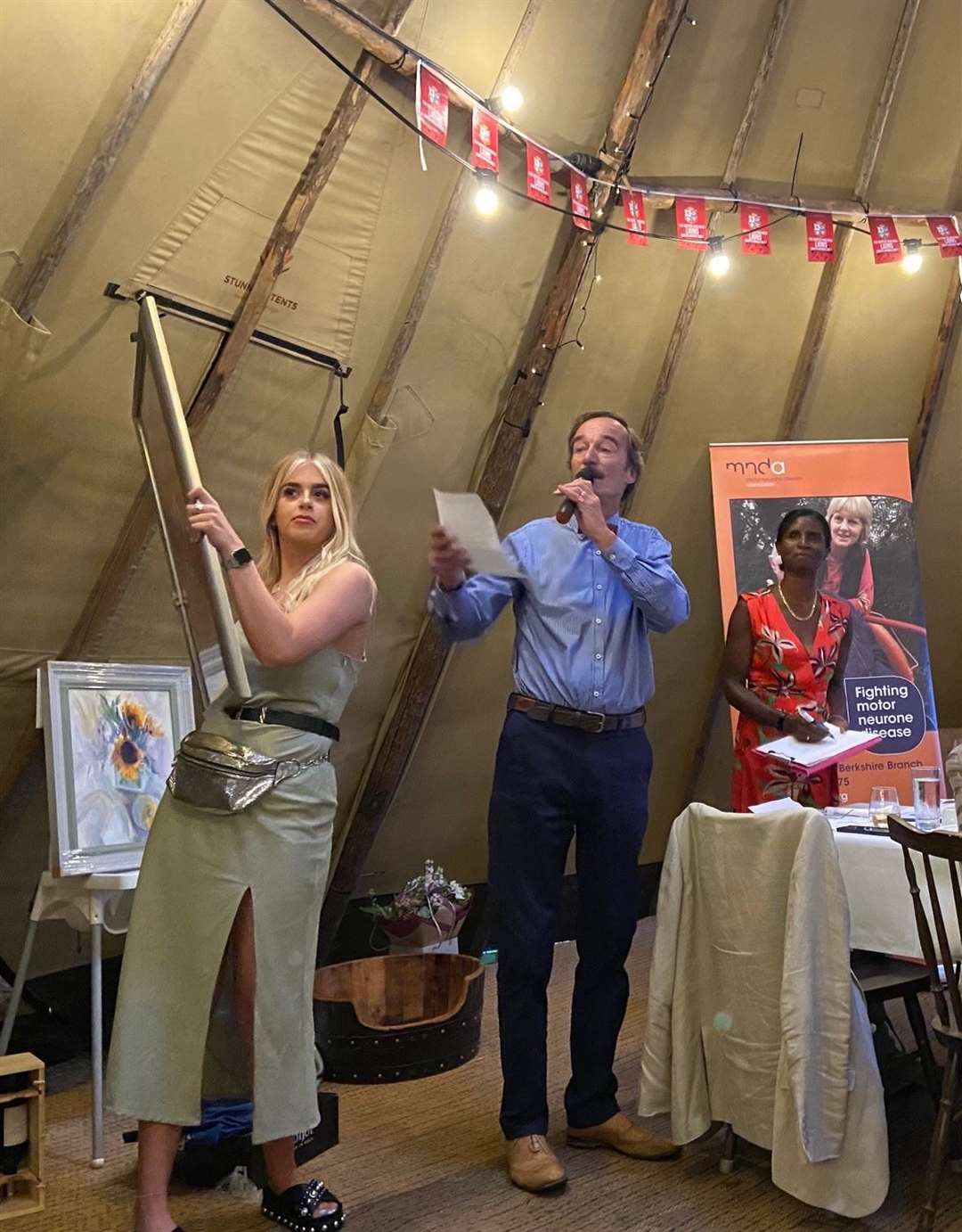 Auctioneer Simon Fryer, from Hampstead Norreys, with assistants Amy Whiting and Janet Martin-Kerr at the MND fundraiser on Sunday.