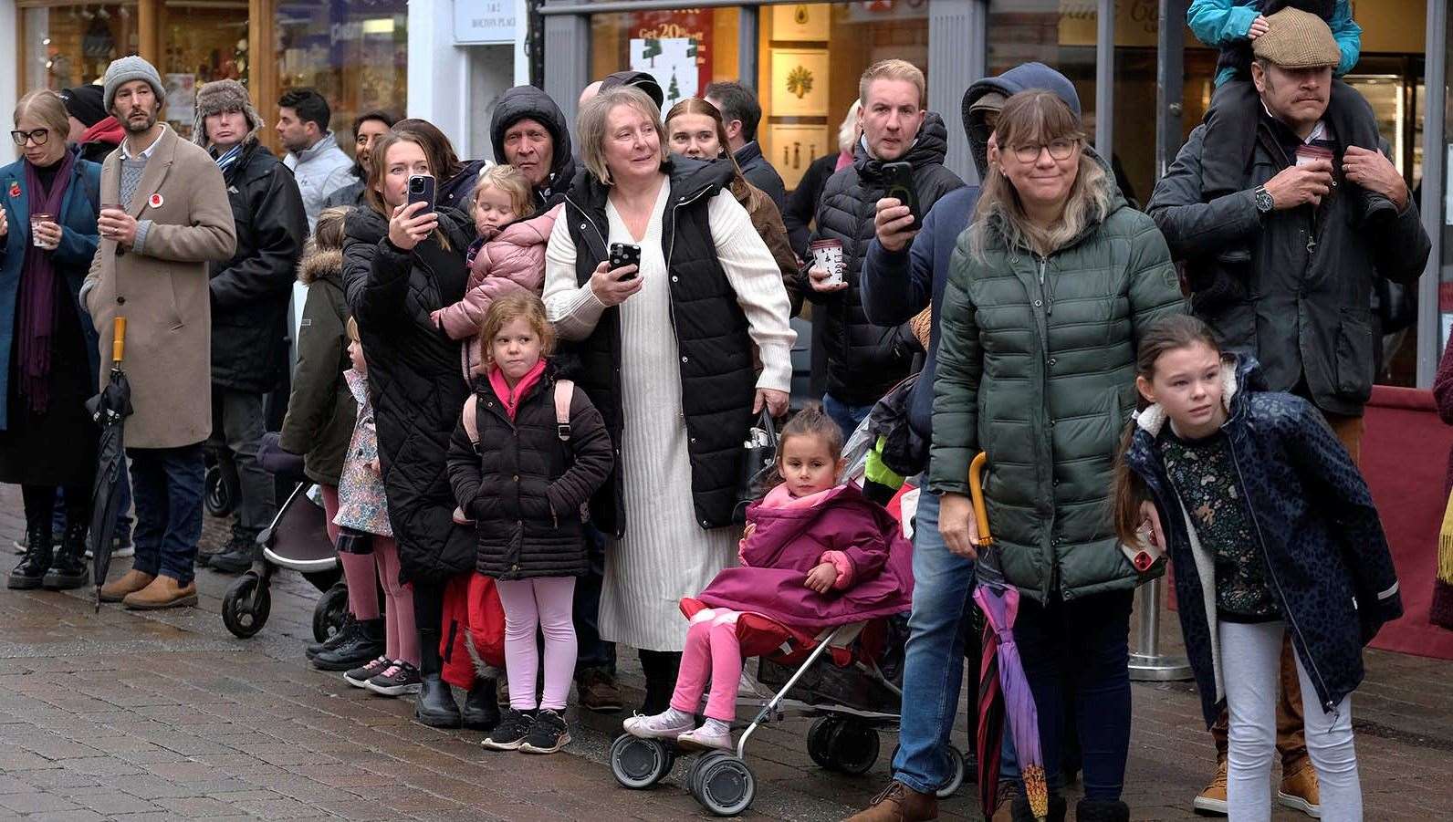 Observers catch the parade along Northbrook Street