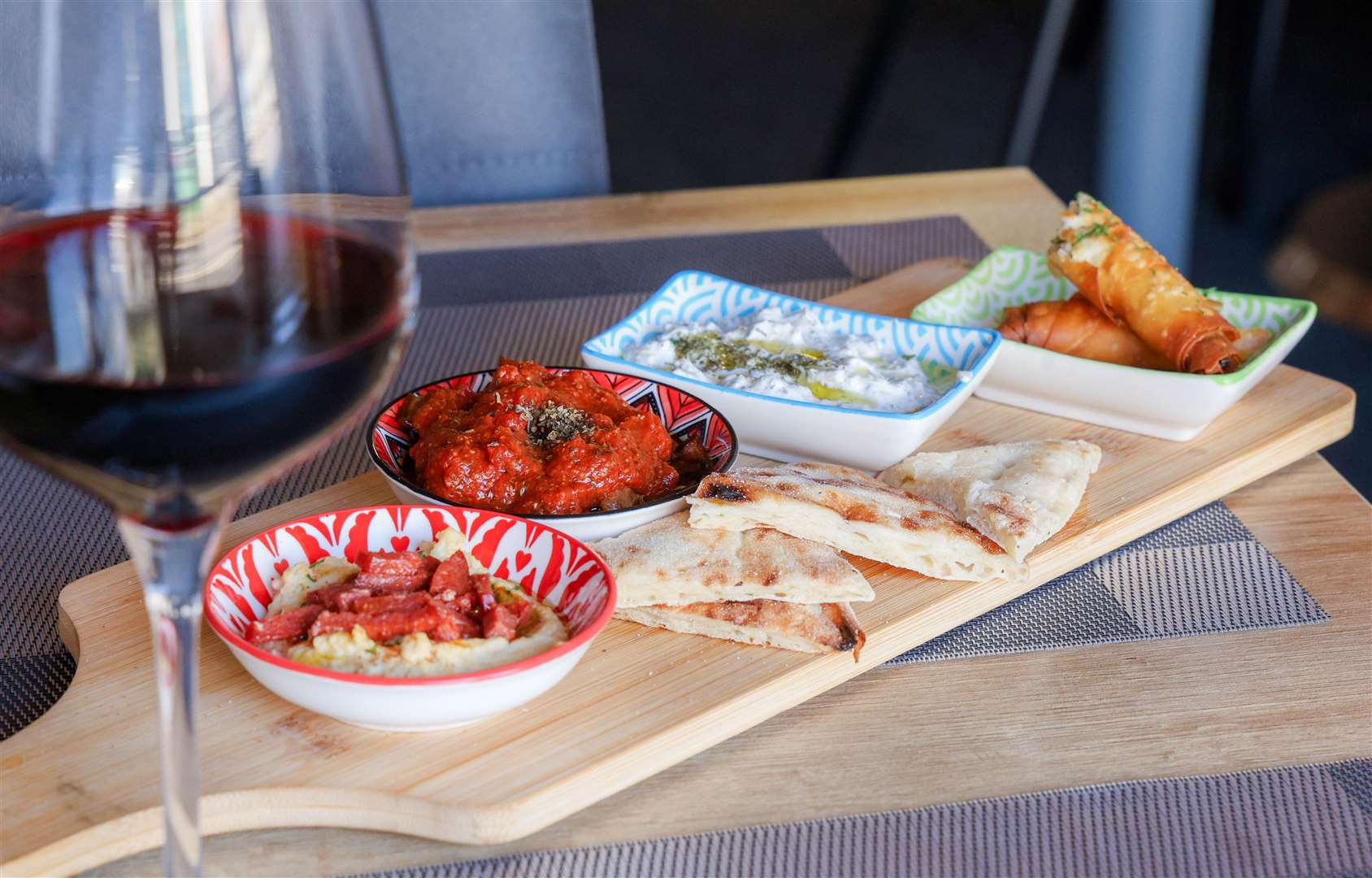 Mezze platter with flatbread, soslu patlican (aubergine in tomato and garlic sauce), sigara boregi (crispy cheese rolls), dry tzatziki and hummus