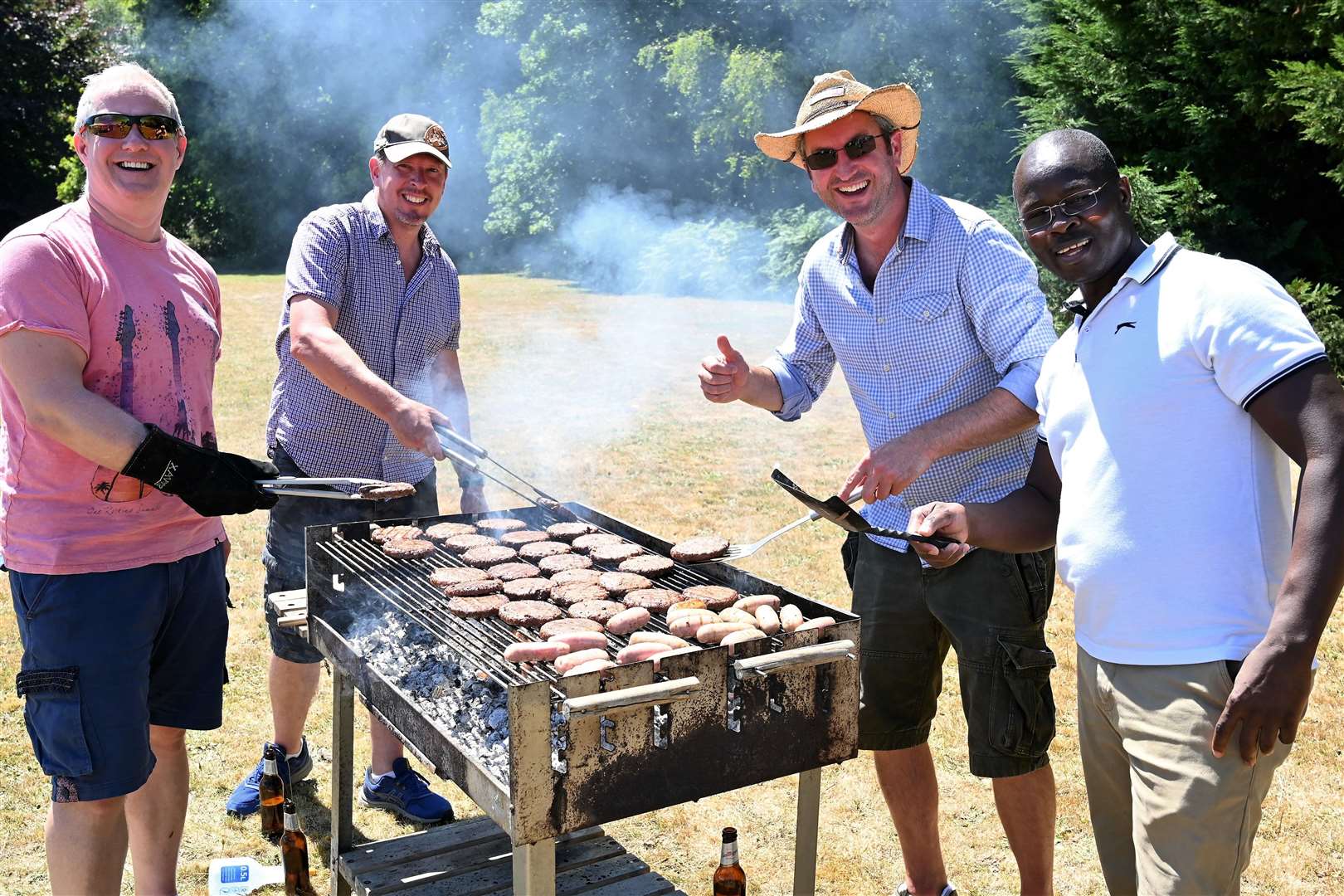 Mike Belcher, Tim Auld, Matt Cooke and Clem Otieno enjoying their time around the barbecue