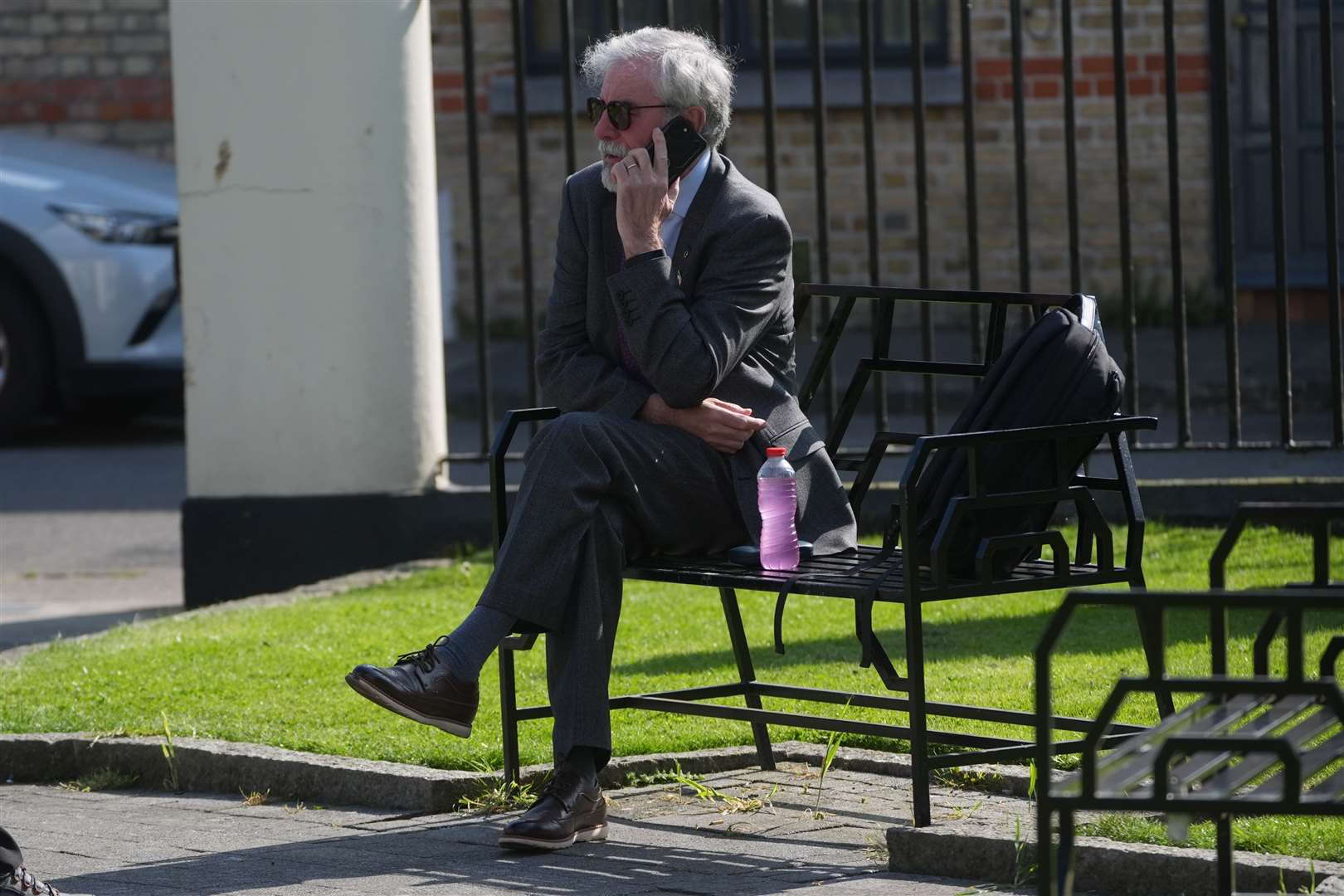 Former Sinn Fein president Gerry Adams makes a phone call in a park near to the High Court in Dublin (Brian Lawless/PA)