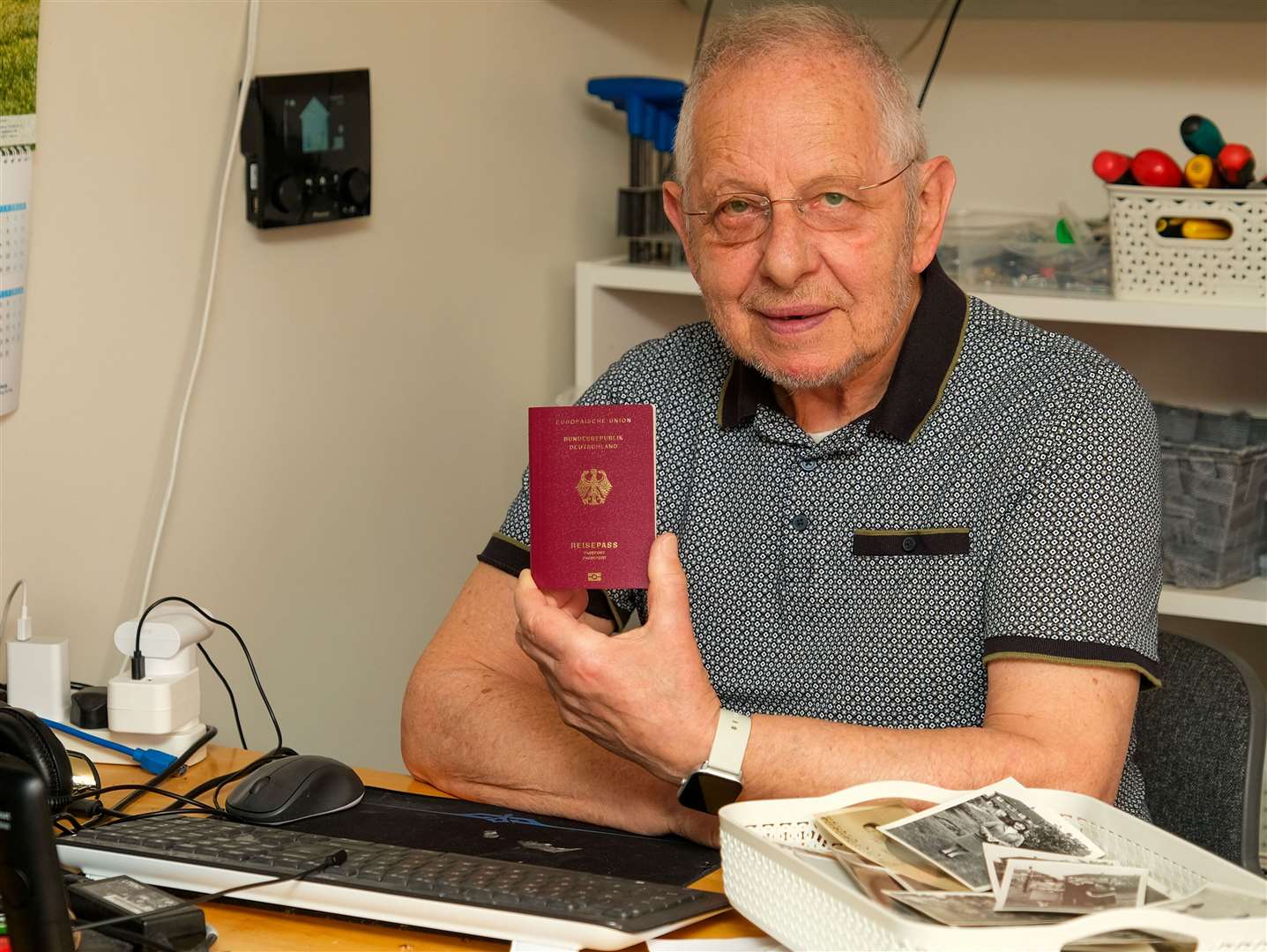 Eric holding his German Passport he obtained in 2022