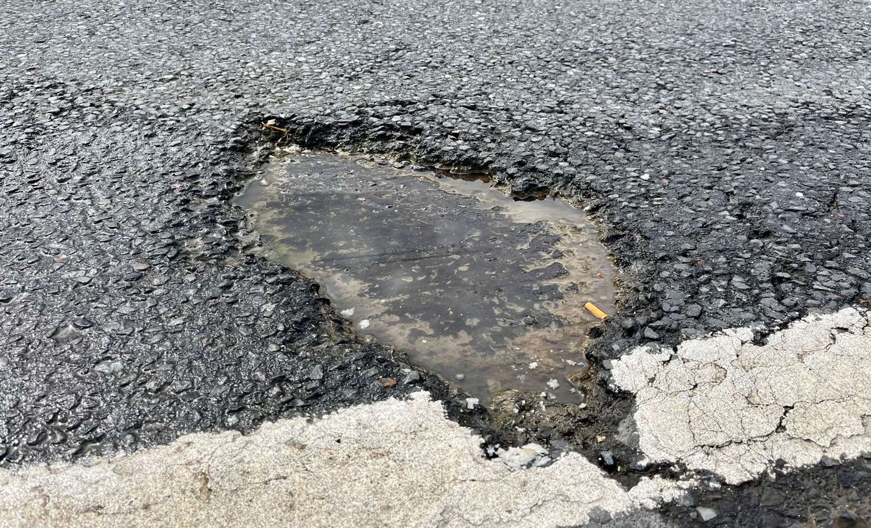 Water leak and potholes on A4 by Henwick Worthy Sports Ground