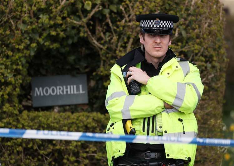 A police officer at the cordon at the junction of Moor Lane and Langham Lane, in Gillingham, Dorset, during the investigation (PA)