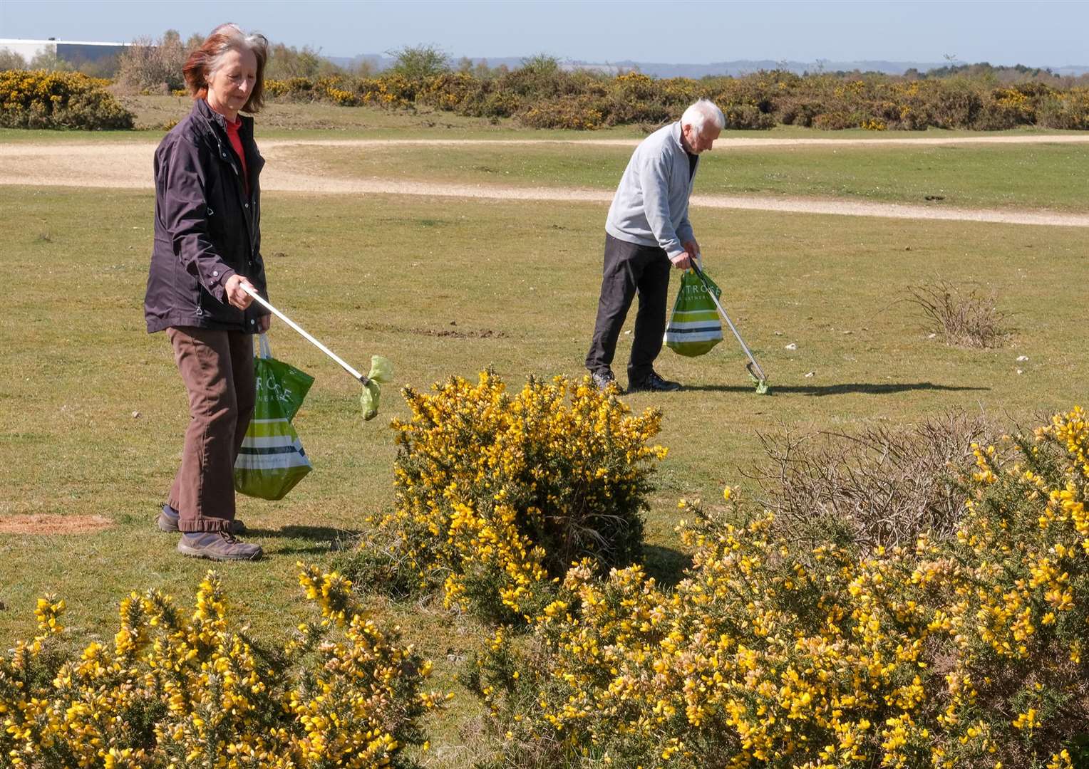 Linda and Cliff Waller picking up the dog poo bags on Greenham Common