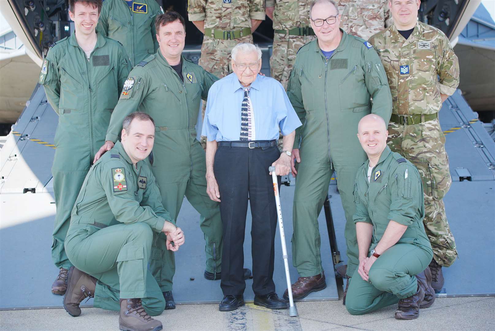 99-year-old Second World War RAF veteran Dennis Bishop, centre, accompanied by air crew of an Airbus A400M Atlas military transport aircraft at RAF Brize Norton (Ben Birchall/PA)