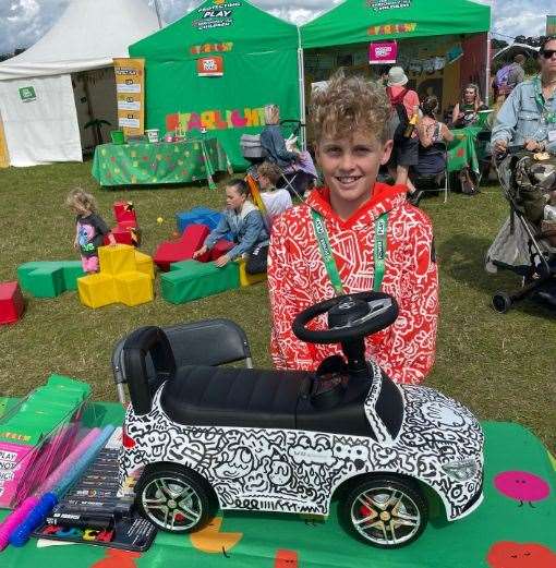 Joe Whale with the doodle-covered toy car at CarFest