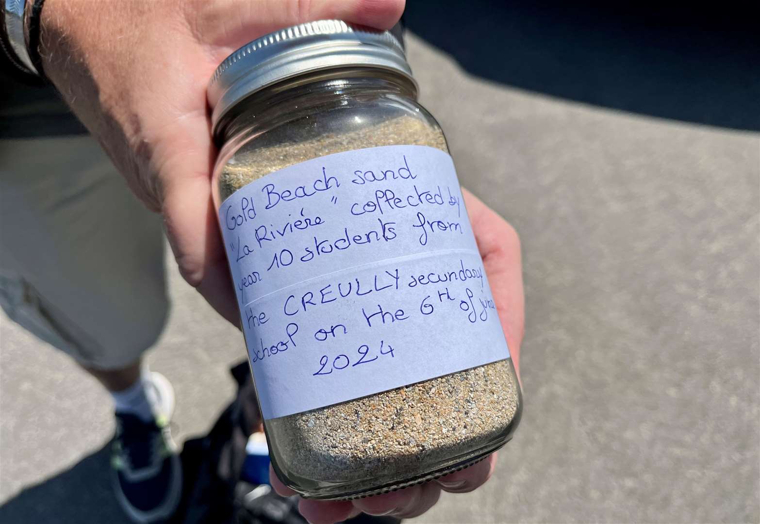A jar of sand collected from Gold Beach by Cecil Newton Secondary School pupils. Credit: Mirek Gosney