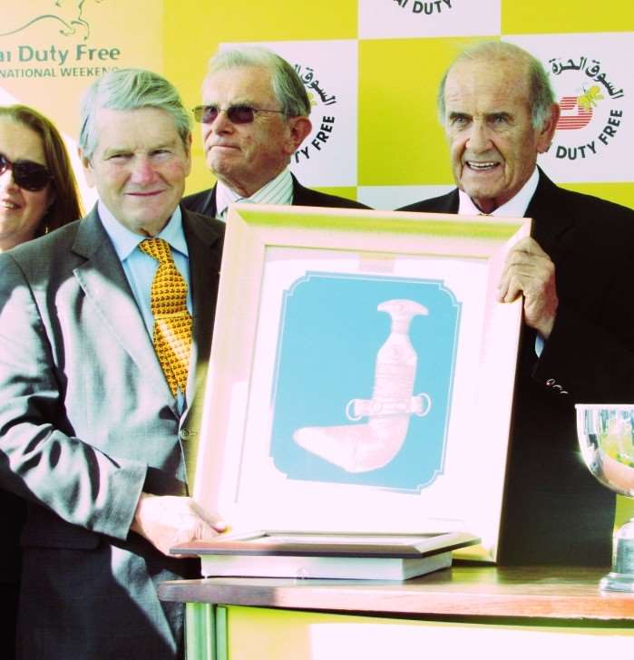 Ian Balding collects a memento from Dubai Duty Free's CEO Colm McLoughlin following Brorocco's success
