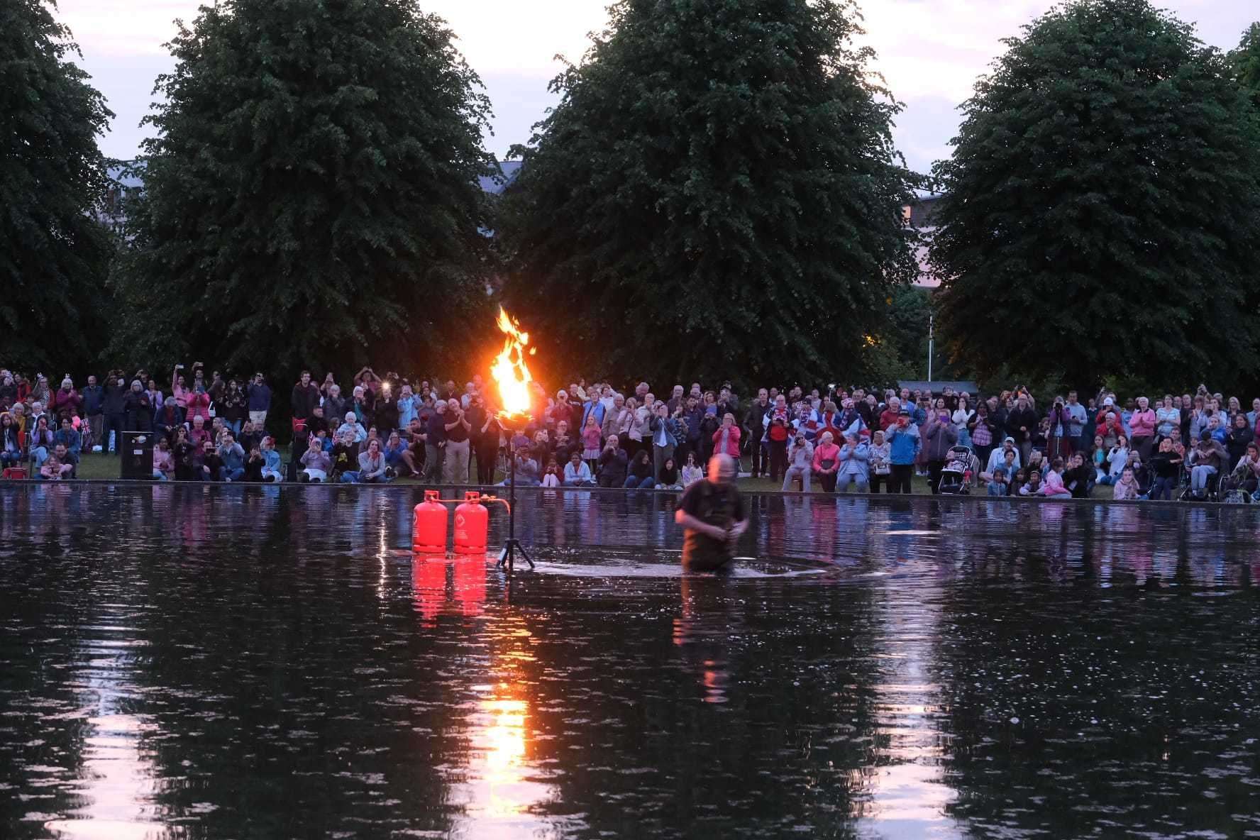 Crowds gather to watch the beacon be lit for the Queen's Jubilee
