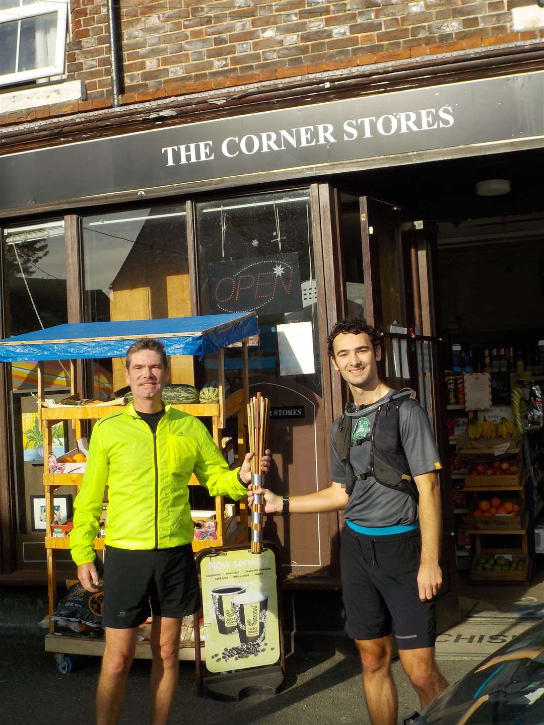 Runner, Keith MacIntosh (left) handing over the baton to runner, David Starley (right)