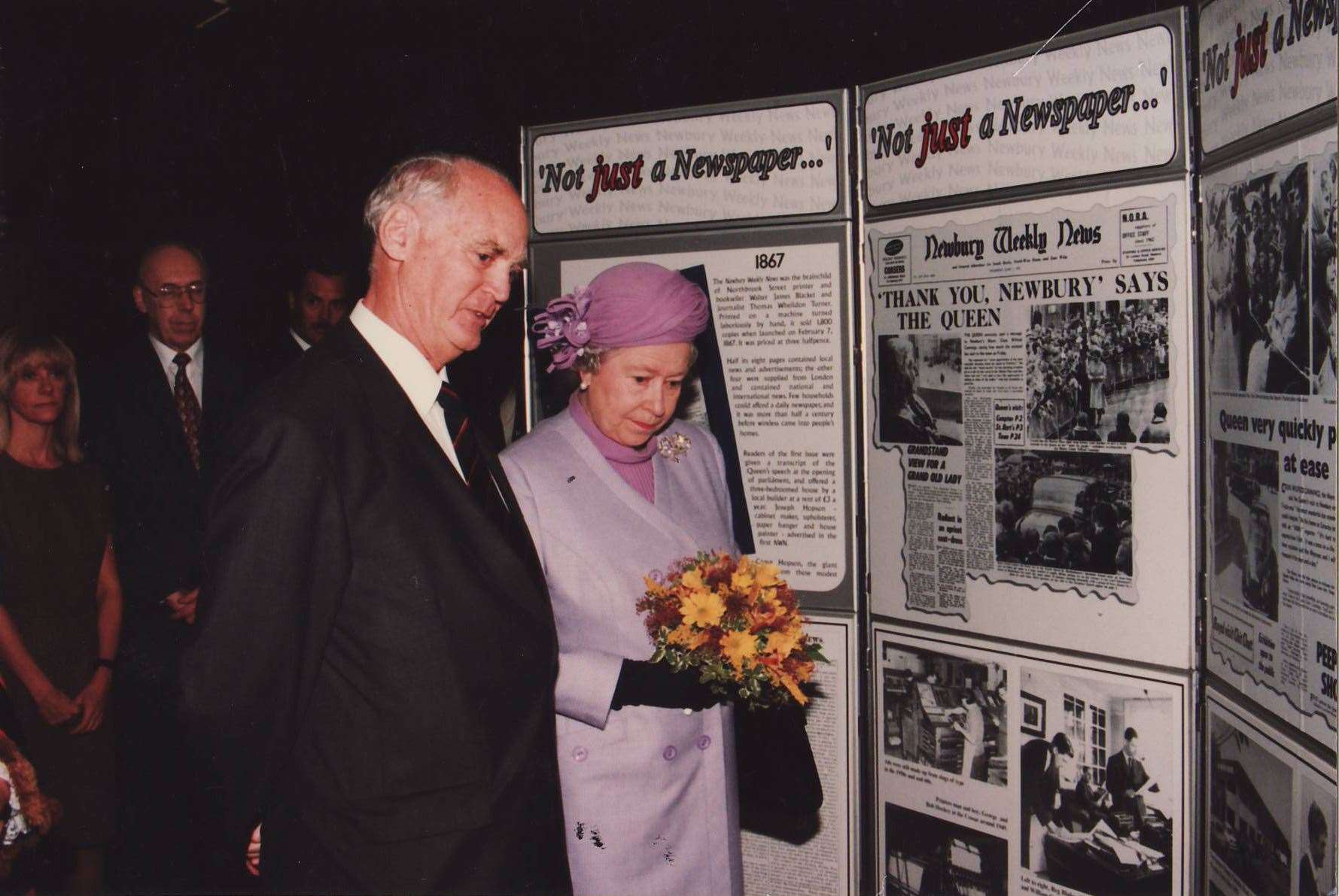 The Queen is shown a display from the Newbury Weekly News by the newspaper's chairman Donald Willis in 1996