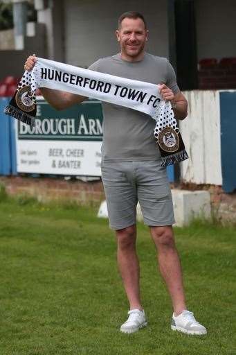 Clarke smiles with a club scarf as he checks out the Bulpit Lane pitch. Picture by Jeff Youd Photography