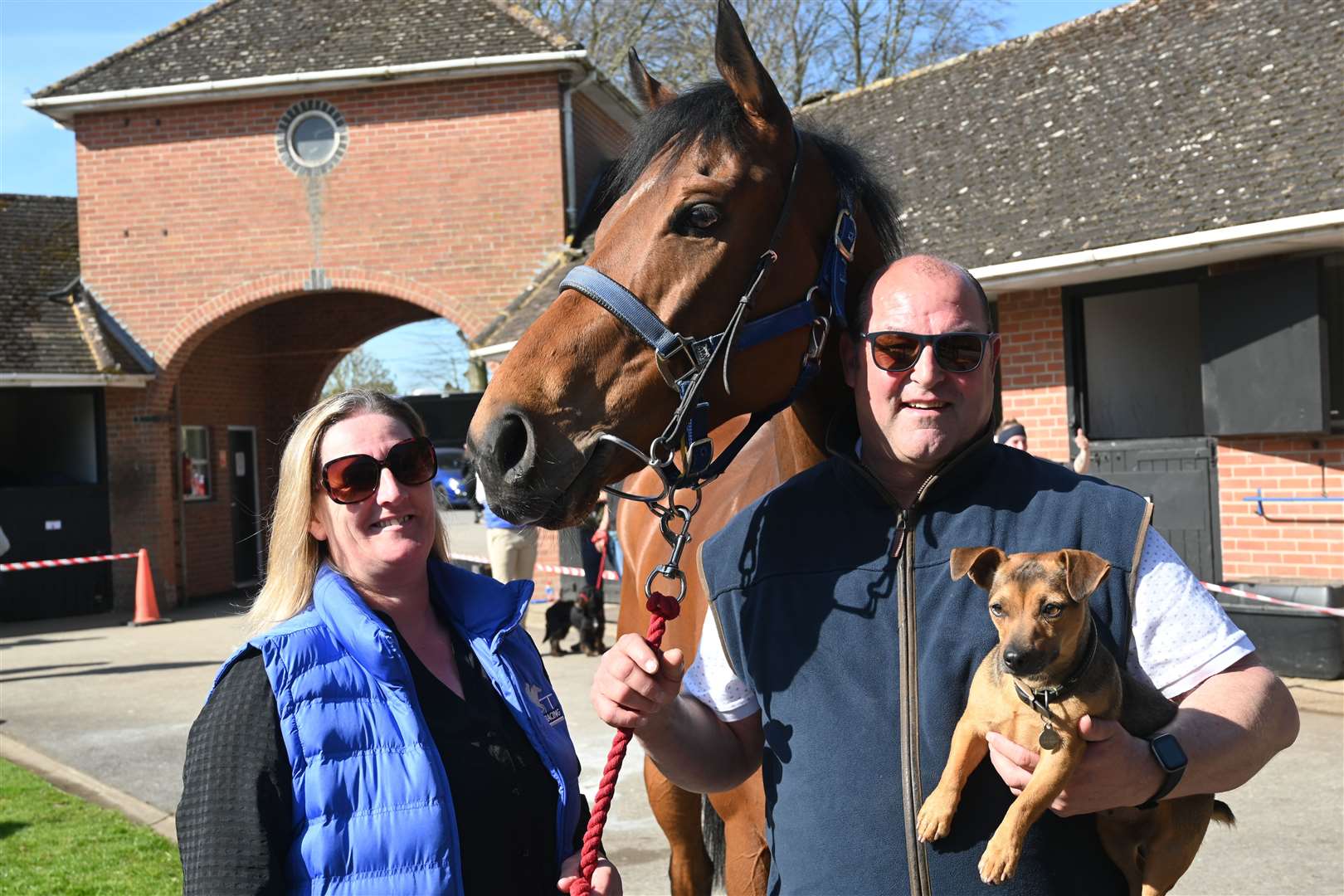 Roger and Sue Teal in their yard with 'Oxted' and Mouse (dog)