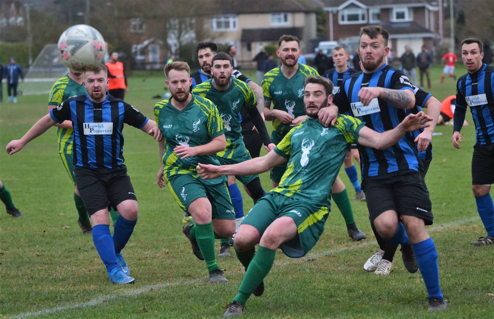 The ball comes into the box as players try and deal with it