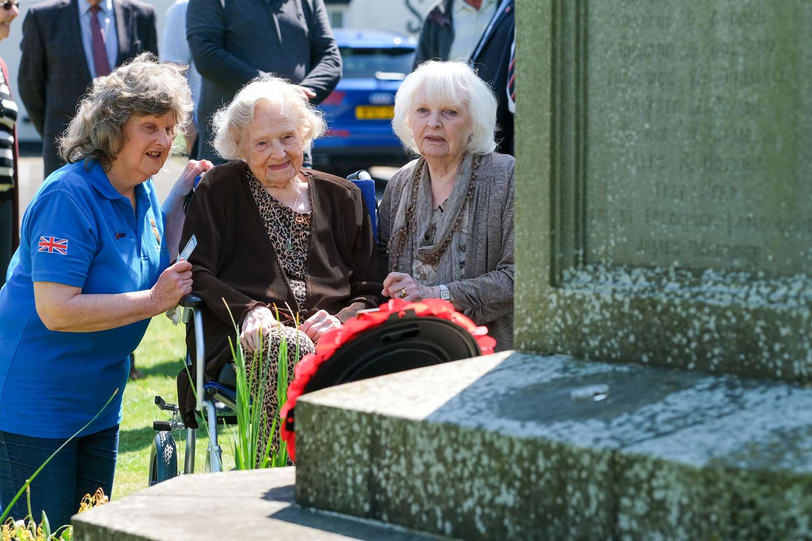 103-year-old Cissie Edward laying a wreath for VE day with daughters Mary Sanger and Ann Howe