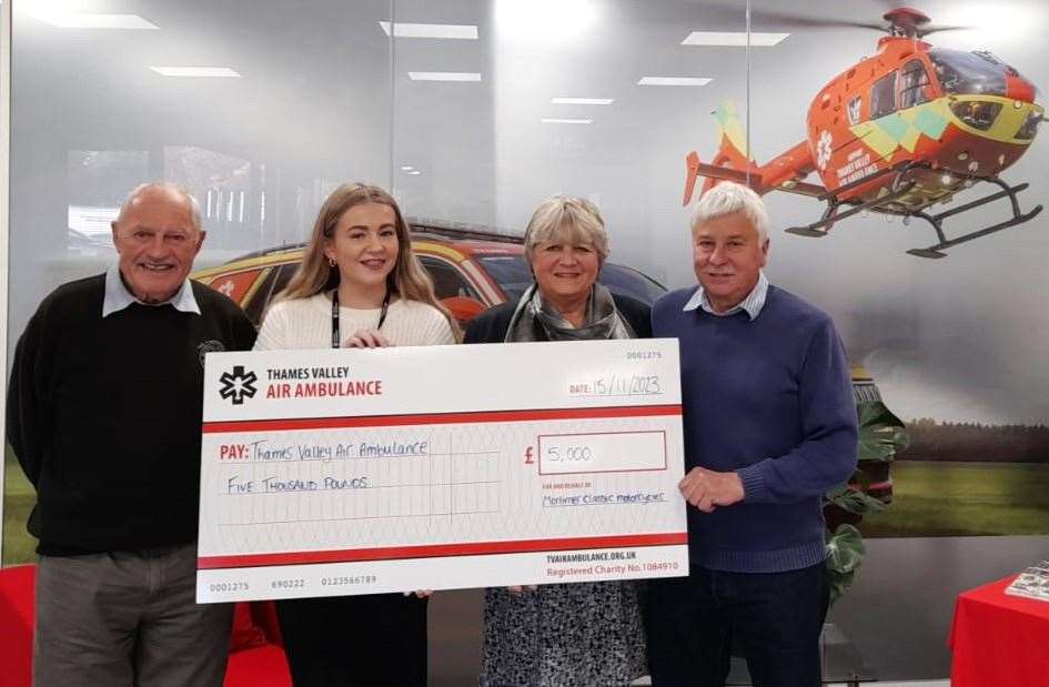 Vice President Mike Smith, Chairman John Dowse and Chris Dowse of Mortimer Classic Motorcycle Club presenting a cheque to the Thames Valley Air Ambulance. Credit: Chris Dowse