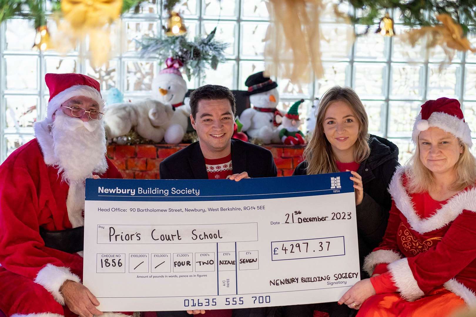 Matthew Wilding and Molly MacLean from Newbury Building Society in Santa’s Grotto with ‘Santa and Mrs Claus’ (Prior’s Court CEO, Ryan Campbell, and director of learning, Sue Piper) during their visit to Prior’s Court. Credit: Michael Harden