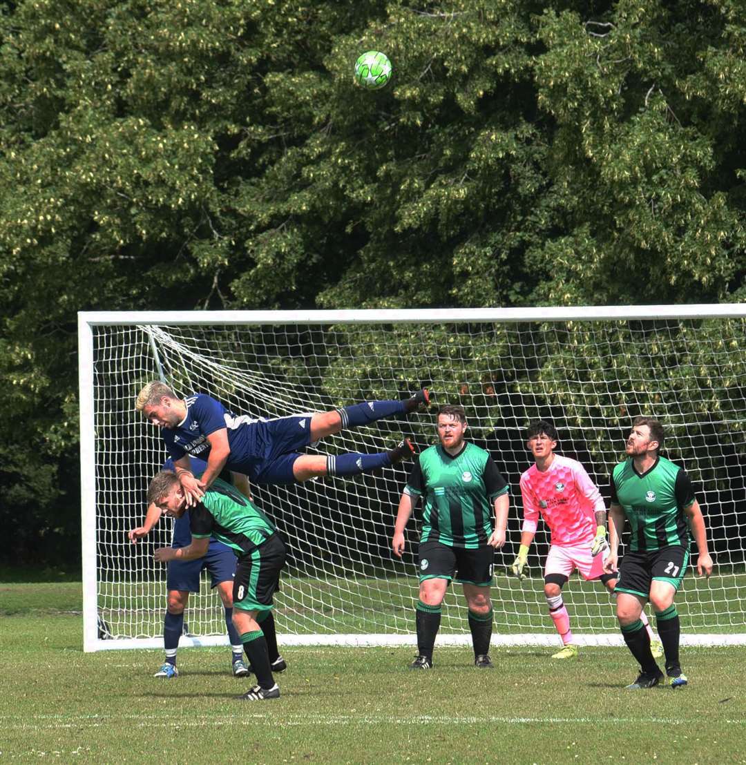 Players challenge for the ball at a corner