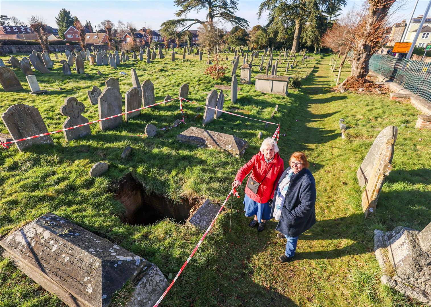 Maureen Hudd and Ros Clow next to the collapsed grave in Newtown Road Cemetery