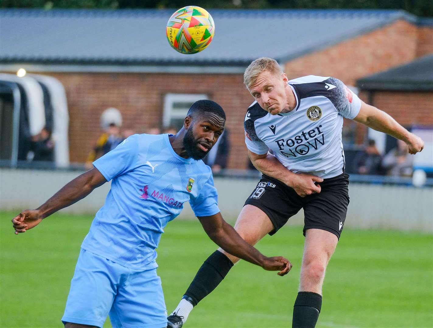 Midfielder Joe Shepherd wins an aerial duel