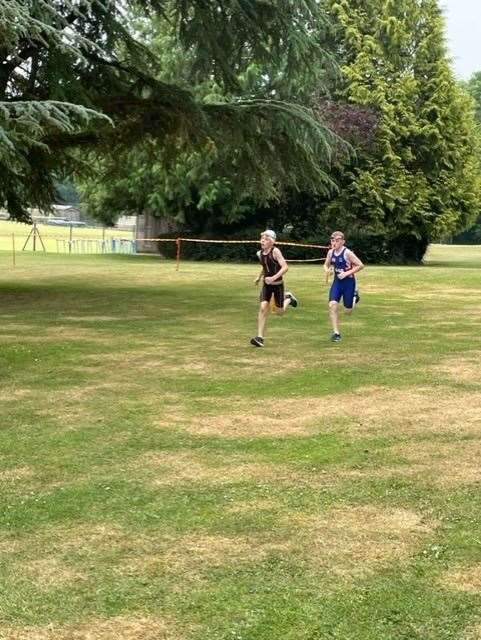 Liam Neil, right, approaches the finish line