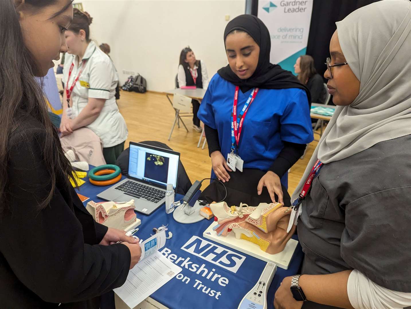 Pupils learning from an audiologist at St Bart's careers fair