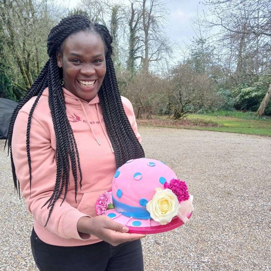 Colline with her cake, decorated to look like a hat