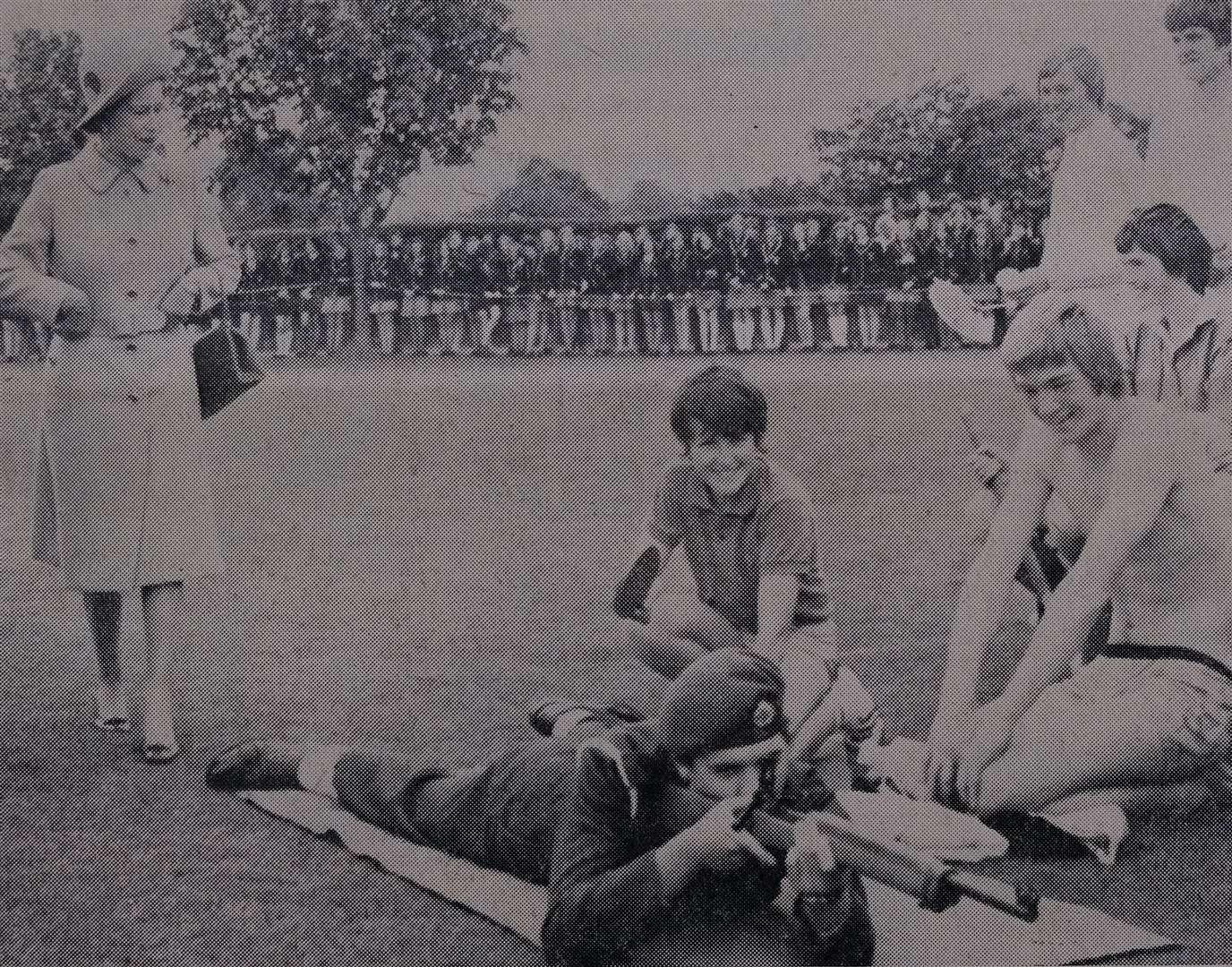The Queen advises St Bart's pupil Gareth Nash (in swimming trunks) to put on extra clothes because of the cold wind and rain
