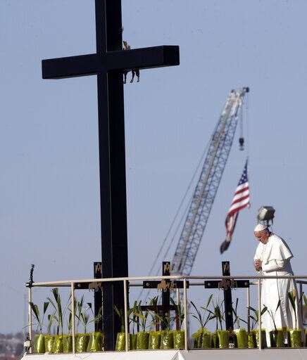 The Pope prays near the US-Mexico border fence along the Rio Grande, in Ciudad Juarez, Mexico in 2016 (Gregorio Borgia/AP)