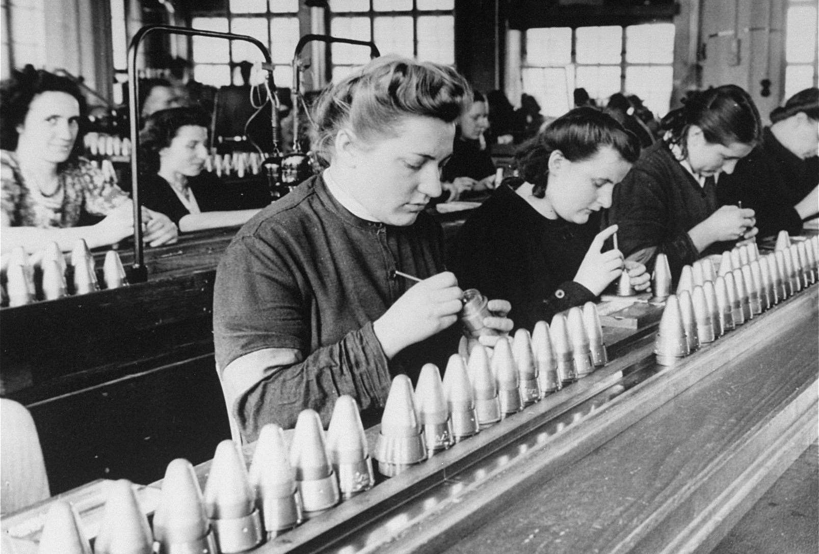 Female foreign workers from Stadelheim prison, Germany working at a factory owned by AGFA in May 1943. Forced and slave labour did not discriminate by age or gender, especially with Central and Eastern European workers. Image in public domain
