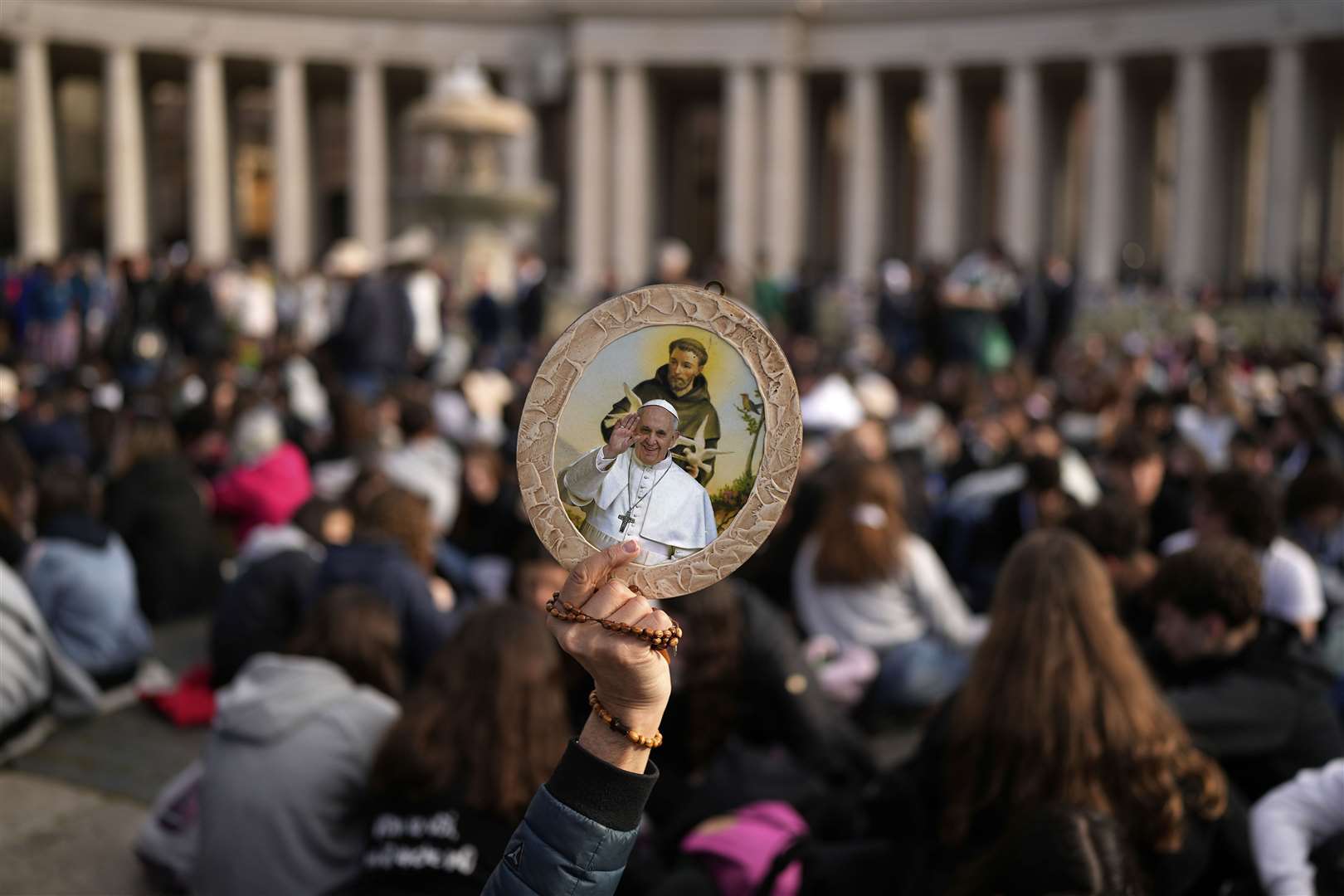 A person holds a depiction of Pope Francis in St Peter’s Square at the Vatican (Andreea Alexandru/AP)