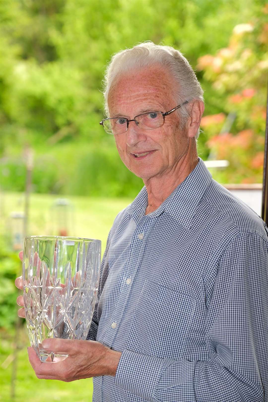 David Hunt with his glass vase that he was gifted by the council