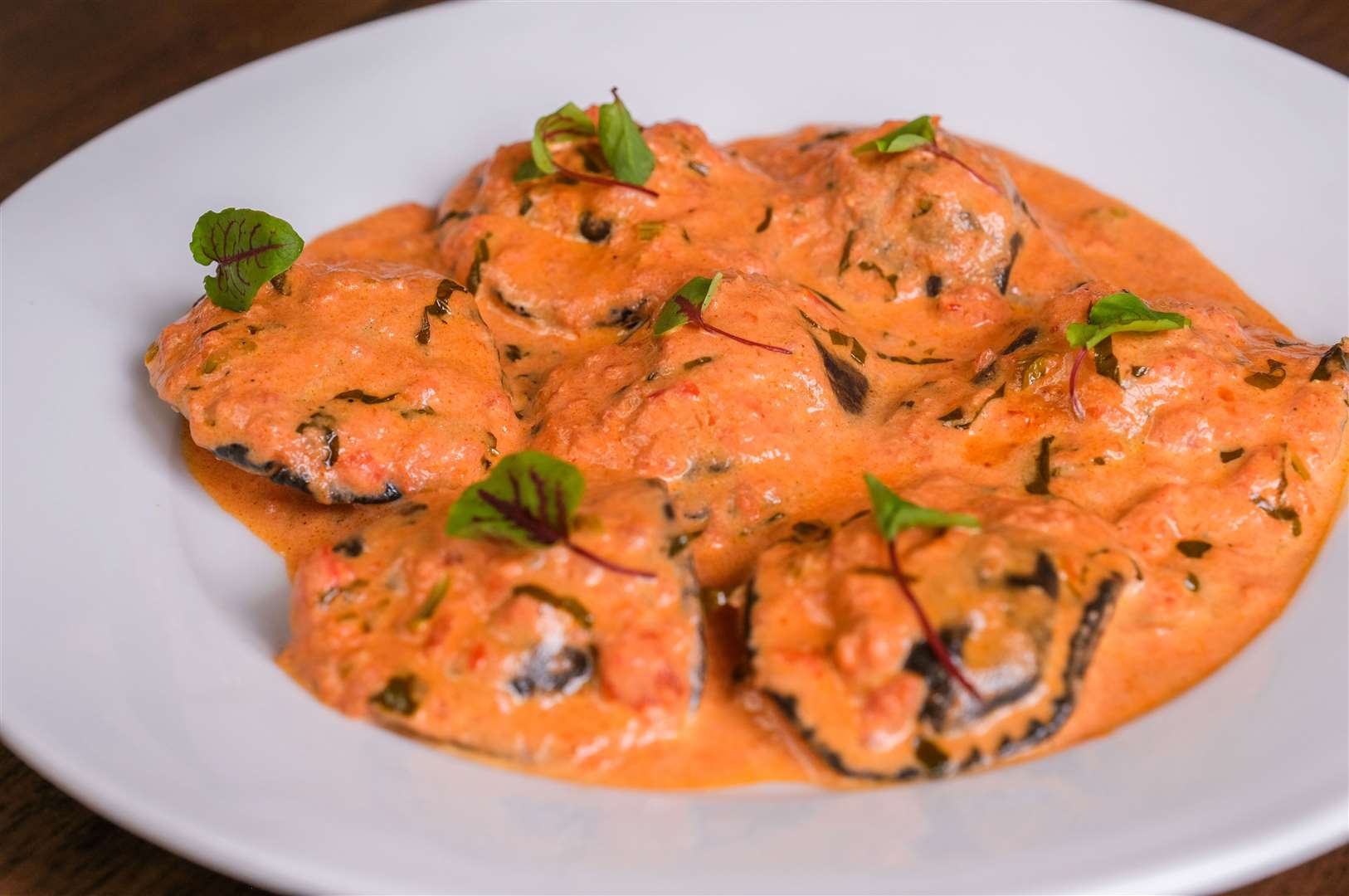 Black sorrentinos with Atlantic salmon and prawns in a tomato, vodka and cream sauce (£18)