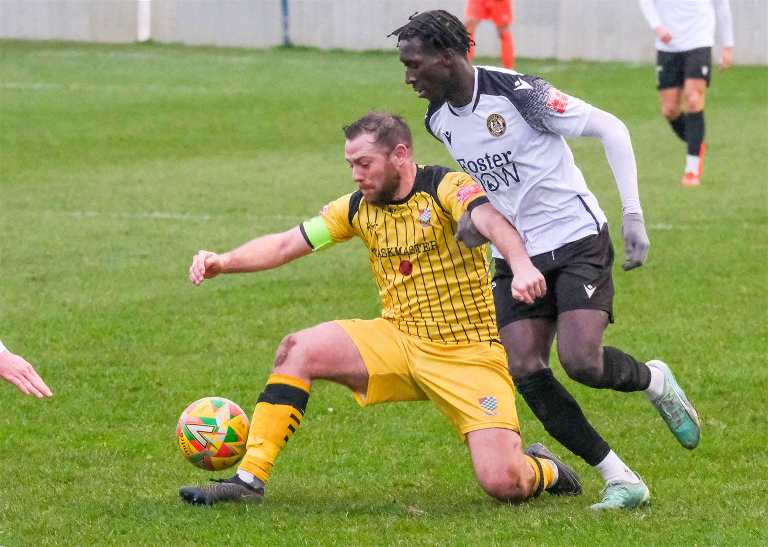 Chesham captain Steve Brown protects the ball from wideman Adulai Sambu