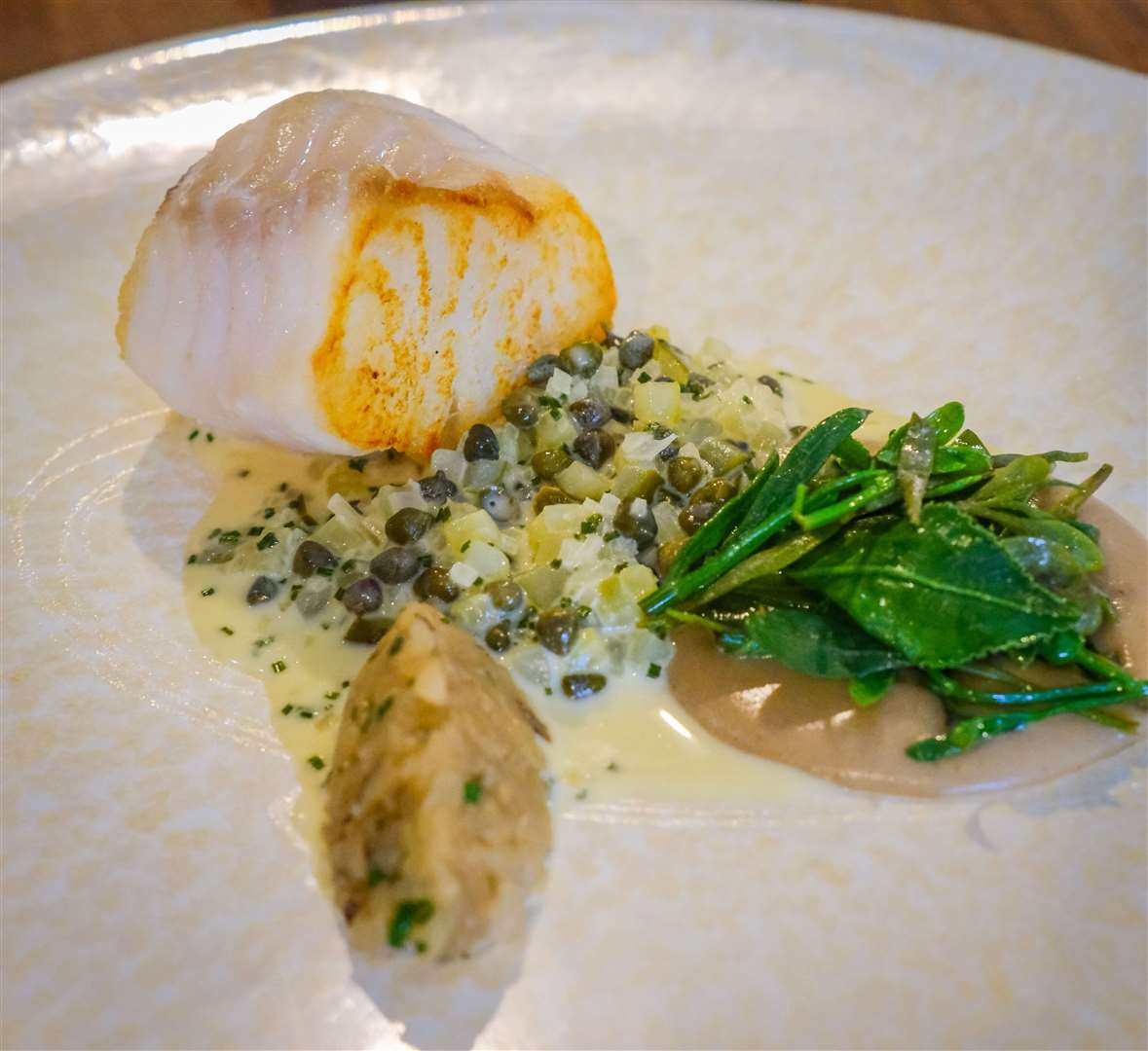 Cod loin with Jerusalem artichoke, warm tartar sauce, sea herbs and pomme soufflé